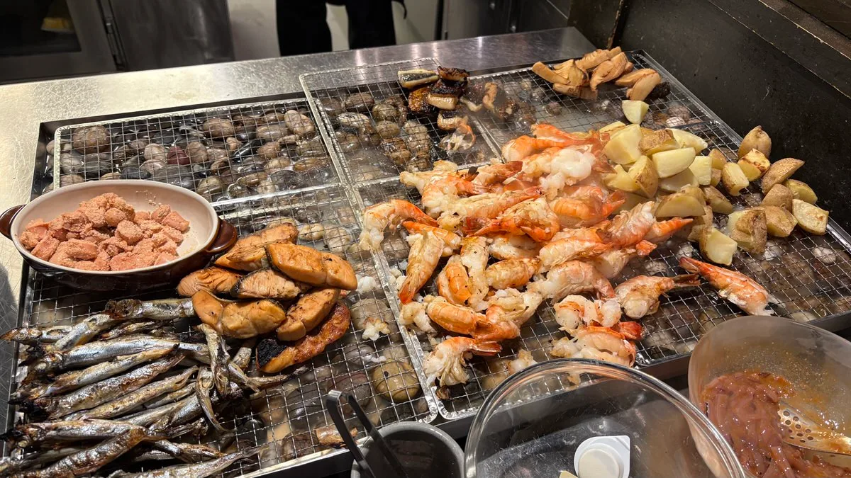 Shrimp, potato wedges and bamboo shoot on the buffet grill station