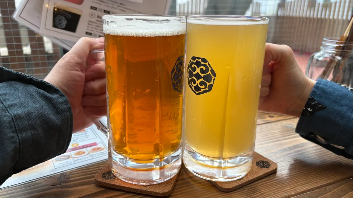 Two large mugs of craft beer on the counter at the tap room