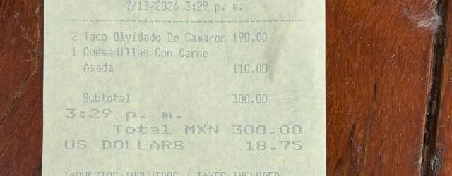 A printed receipt dated 7/13/2026 3:29 p.m. listing 2 Taco Olvidado De Camaron 190.00 and Quesadillas Con Carne Asada 110.00, total MXN 300.00, US dollars 18.75